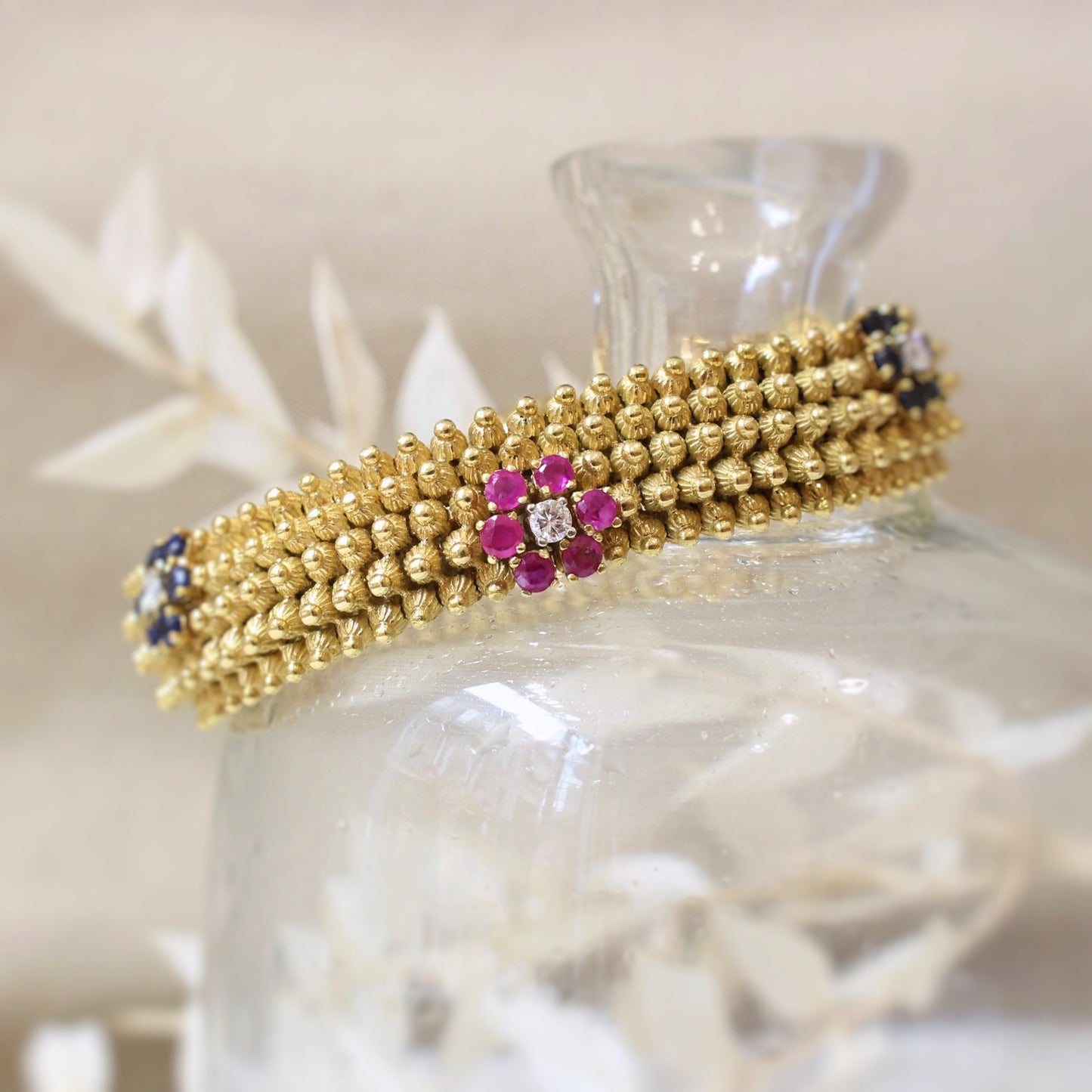 Bracelet maille tubogaz en or jaune orné de fleurs de saphirs et diamants